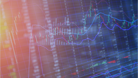 Pomarańczowo-niebieska grafika przedstawiająca wzrosty i spadki akcji na giełdzie